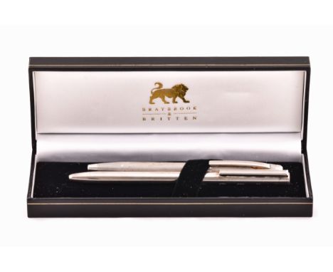 A sterling silver slim ball point pen with feature large hallmarks for London 2003 by Braybrook &amp; Britten, together with 