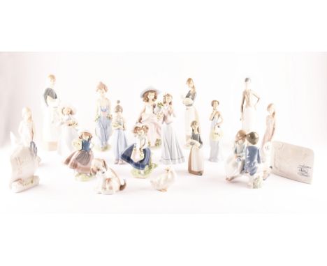 A large collection of Lladro, including fourteen female figurines, a puppy, a Lladro society scroll, a Lladro collector socie