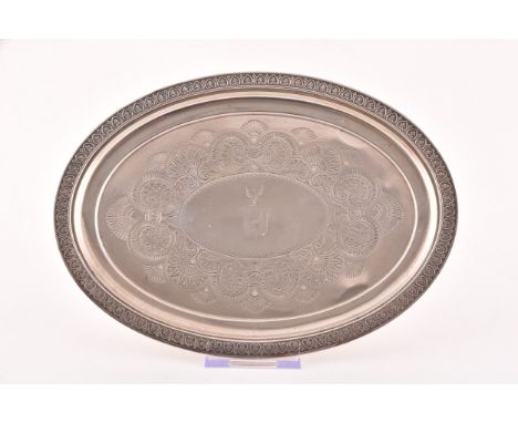 A George IV silver oval shaped tray, Hallmarked Birmingham 1820, with engraved crest and decoration, 25.5 cm length x 19 cxm 