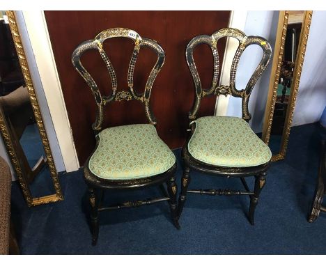 A pair of Victorian ebonised and mother of pearl inlaid cane work chairs