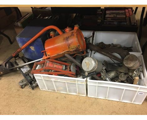 A hydraulic trolley jack and various metal tools