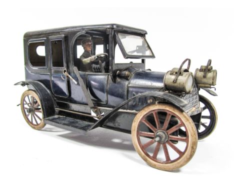 A 1910 Clockwork Tin Car, probably by Bing of Germany. Tin wheels and tyres, push opening windscreen, hand brake, opening rea