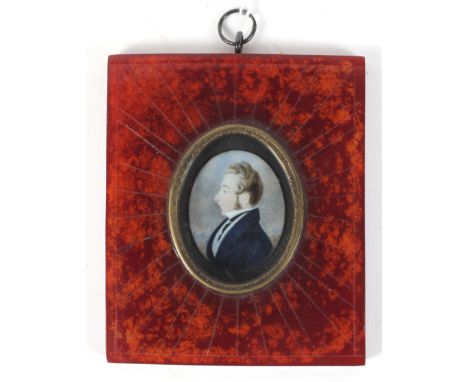 A 19th century minature portrait on ivory depicting a gentleman set in a stained red frame