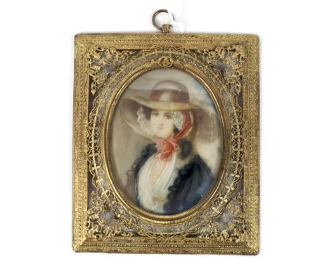 A 19th century minature portrait on ivory. Depicting a lady wearing a bonnet set in a decorative filigree gilt frame