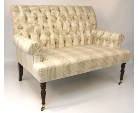 A two seater button back sofa. With cream checked upholstery raised on turned supports and casters, L125cm x H95cm Condition 