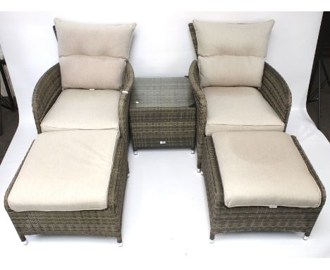 Suite of garden furniture. Comprising a pair of armchairs with cushions, coffee table and pouffe Condition Report: All items 