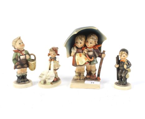 An assortment of four Hummel Goebel figures of children. Largest H15.5cm