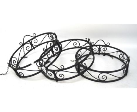 Three contemporary metal ceiling light fittings with shades. Of circular form, each with scrolling decoration to the sides, 4