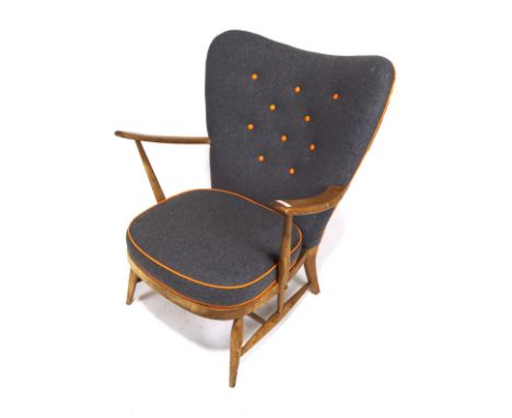 A rare Ercol model 312 1950s vintage wing back lounge chair. Constructed from beech and elm, newly upholstered in grey and or