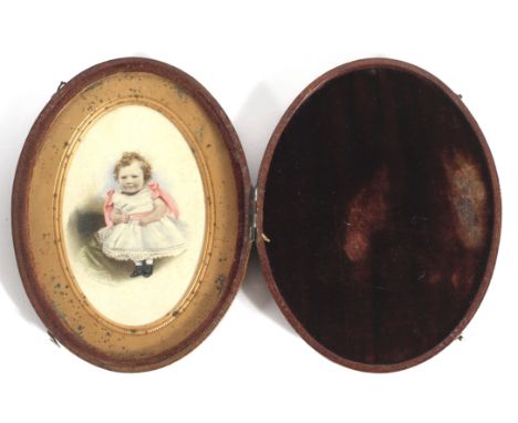 A Victorian portrait miniature of a child on ivory. Of oval form, in leather case, 12 cm long 