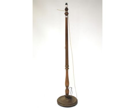 A mahogany standard lamp. Of turned tapering form, with ciruclar base, H153cm