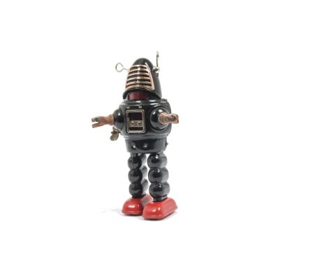 A Yoshiya K.O (Japan) Key Wound Planet Robot, early version with rubber hands, black tinplate body, red feet, G, restored to 