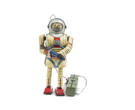 A Nomura T.N (Japan) Battery-operated Remote-control Earth Man, fawn yellow lithographed tinplate astronaut, silver helmet, r