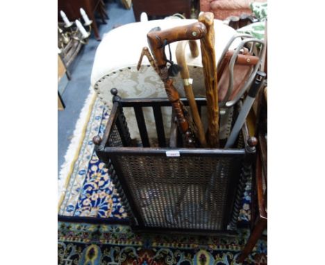 A 1920'S OAK AND CANE STICK STAND with contents