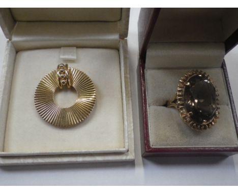 A LARGE SMOKEY QUARTZ RING, on 9ct gold shank, together with and yellow metal brooch