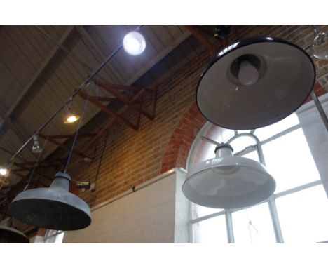 A GALVANIZED STEEL INDUSTRIAL HANGING LAMP, 50cm diam, another similar in white enamel and a smaller black enamel example