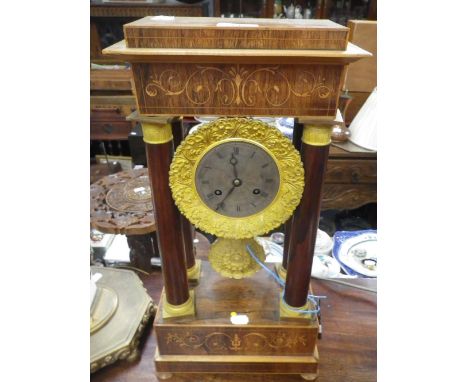 A 19TH CENTURY FRENCH EMPIRE STYLE PORTICO MANTLE CLOCK, the silvered dial with Roman numerals, cast gilt bezel and pendulum,