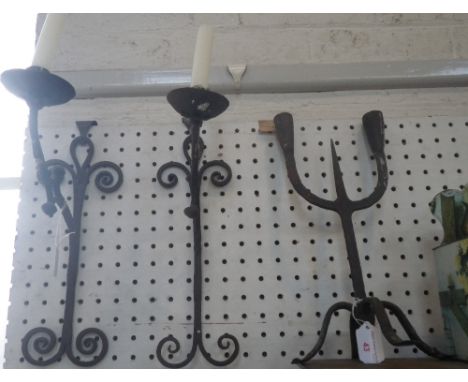 A PAIR OF RUSTIC GOTHIC STYLE WALL CANDLE SCONCES and a similar two branch candlestick