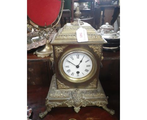 A VICTORIAN CAST BRASS CASED SINGLE TRAIN MANTEL CLOCK with enamel dial