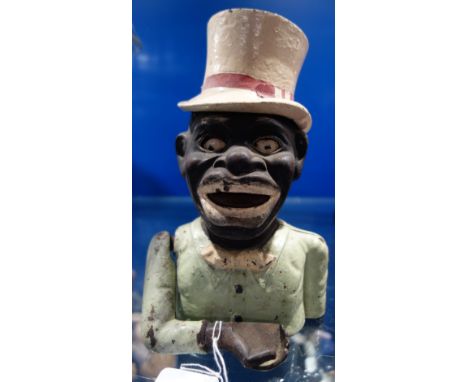 A VINTAGE AMERICAN CAST IRON NOVELTY MONEY BOX in the form of a black man, 21cm high