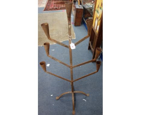 A RUSTIC METAL SEVEN BRANCH CANDLESTICK
