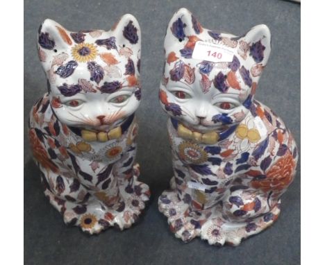 A PAIR OF CHINESE CERAMIC CATS with allover floral design, 38cm high