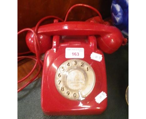 A VINTAGE RED PLASTIC TELEPHONE
