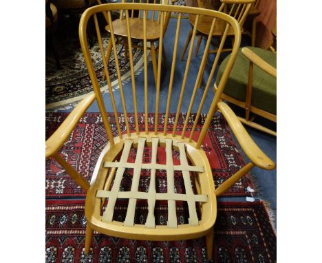 ERCOL; A PALE BEECH STICK BACK ARMCHAIR (no cushions)