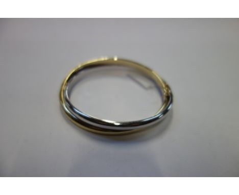A 9CT WHITE AND YELLOW GOLD HINGED BANGLE, the concealed clasp stamped "375"