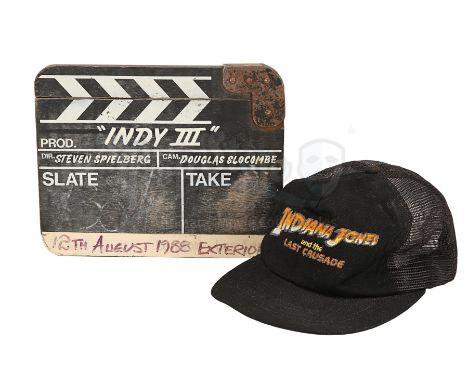 A production-used clapperboard and crew cap from Steven Spielberg's action-adventure sequel Indiana Jones and the Last Crusad