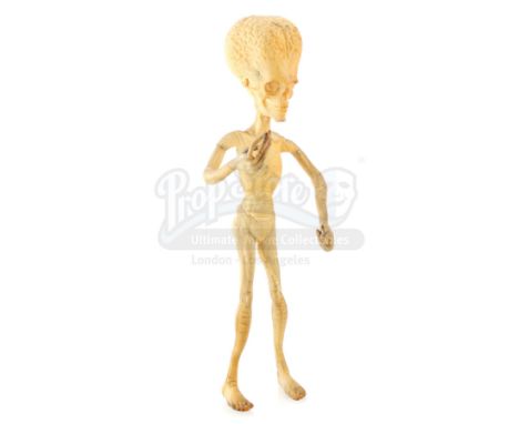 A tan martian stop-motion puppet miniature from the production of Tim Burton's sci-fi comedy Mars Attacks!. Based on the Topp