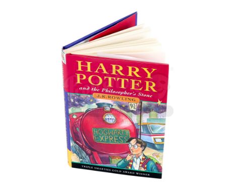 A copy of the novel Harry Potter and the Philosopher's Stone autographed by the three principal actors from the film adaptati