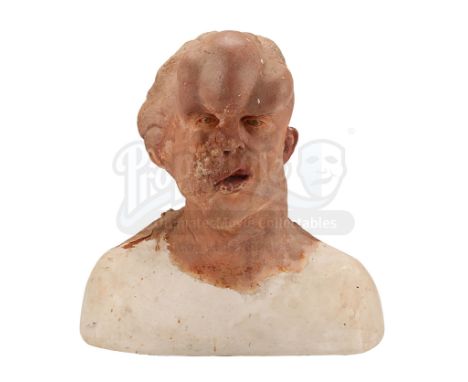 A makeup reference cast and archive photos used to create the prosthetics for John Merrick's (John Hurt) head, from the produ