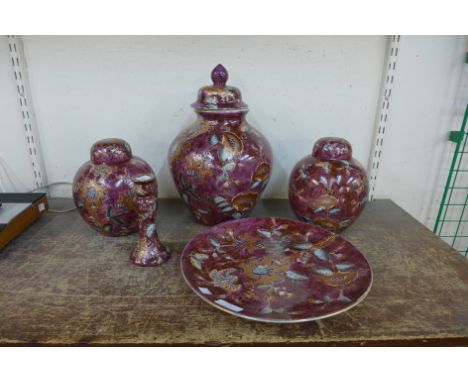 Three Chinese scarlet porcelain jars and covers, a plate and candlestick 