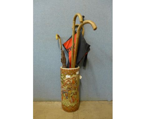 An oriental satsuma porcelain stick stand, with walking sticks 