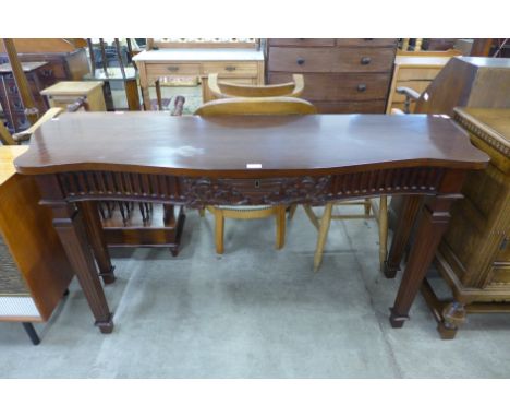 A Regency style carved hardwood serpentine single drawer console table 