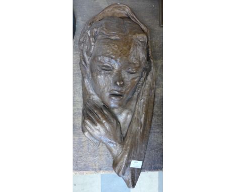 An Art Nouveau style concrete wall mask 