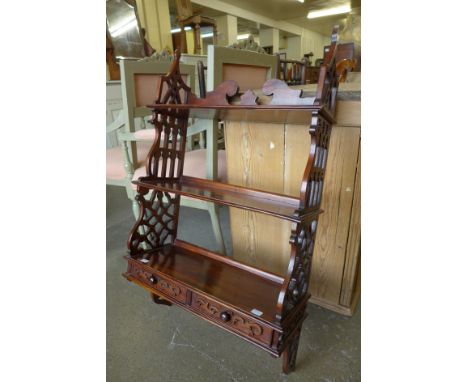 A Chippendale style carved hardwood three tier wall shelf 