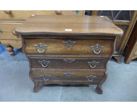 A small French oak bombe shaped commode 