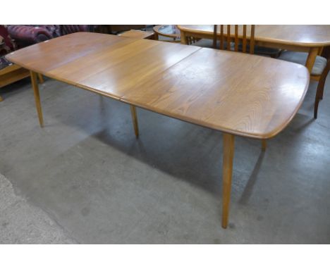 An Ercol elm and beech extending Grand Windsor dining table 