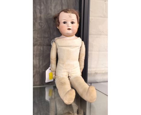 An Armand Marseille bisque head doll 370 with sleeping blue eyes, open mouth with four teeth and jointed leather body, 42cm. 