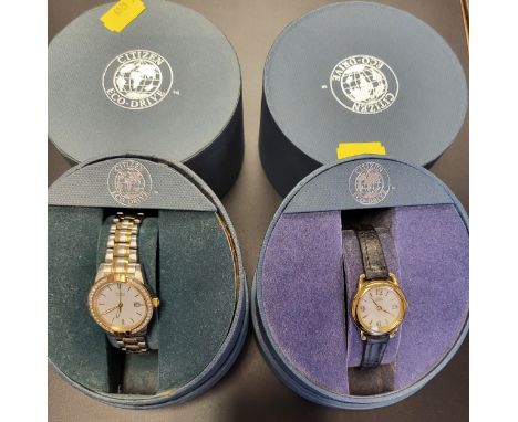 Two ladies Citizen Eco Drive watches in presentation cases, both date just, one on a leather strap, the other a dress watch o