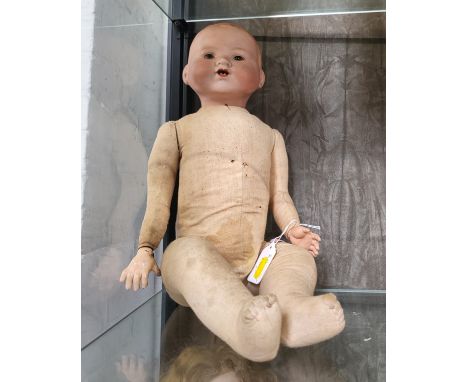 An Armand Marseille 9990/3 bisque head doll with sleeping brown eyes, open mouth with two teeth and jointed composition body,