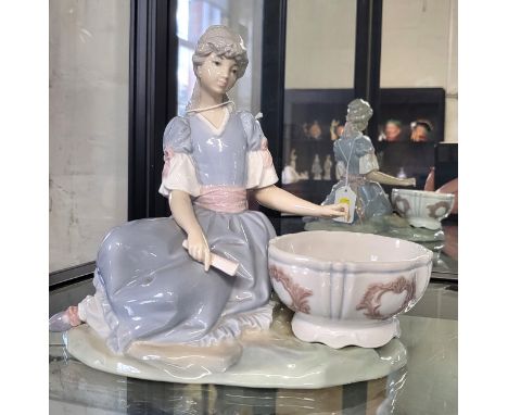 Lladro figure of a girl seated with a basin. 20cm wide 