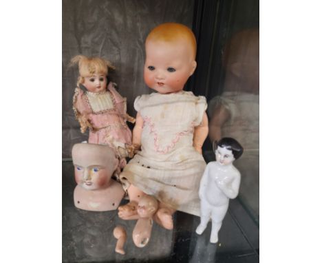 A small German bisque head doll marked W 12/0 12cm, qa bisque head doll with sleeping blue eyes, 32cm, an Empire bisque head 