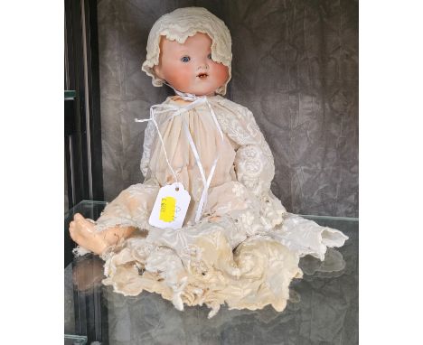 An Armand Marseille 351/31 bisque head baby doll with fixed blue eyes, open mouth with two teeth and composition body, 32cm. 