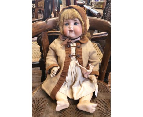 An Armand Marseille 990/12 bisque head doll with sleeping blue eyes, open mouth with two teeth and jointed composition body, 