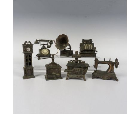 A collection of age patina copper desk accessories in various forms of vintage household products. Such as a grandfather cloc