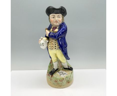 A colonial man adorned in blue and yellow, clutching a pitcher and pipe, standing proudly on a serene grassy plain. Dimension