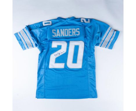 This light blue Lions jersey with white and grey lettering is signed by the famous running back Barry Sanders. Marked XL, mea